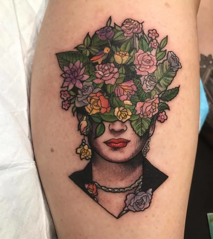 Colorful tattoo with flowers covering a person's head, perfect tattoo idea for every ink lover.