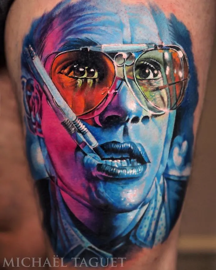 Colorful portrait tattoo of a person with glasses, showcasing vibrant ink ideas for tattoo lovers.