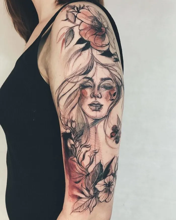 "Artistic floral and portrait tattoo design on a woman's arm, perfect for ink lovers seeking unique tattoo ideas."