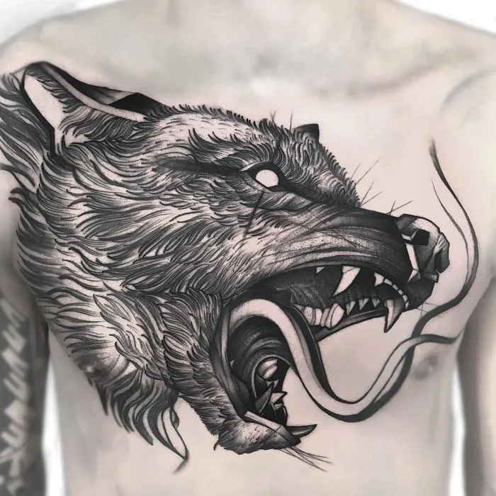 Wolf head tattoo on chest, detailed black and gray ink, perfect for ink lovers seeking bold tattoo ideas.