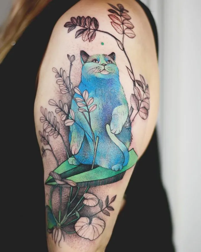 Colorful cat tattoo on arm with floral accents, perfect idea for ink lovers seeking creative designs.