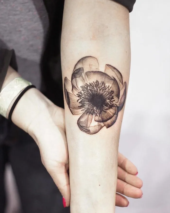 Realistic flower tattoo on forearm, perfect for ink enthusiasts.