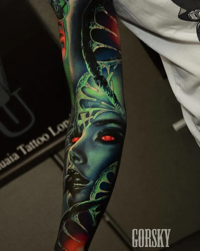 Colorful sleeve tattoo design featuring a futuristic face with red eyes, ideal for ink lovers.