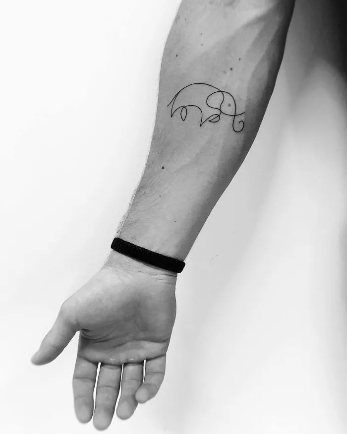 Minimalist elephant tattoo on forearm, perfect for ink lover seeking unique tattoo ideas.