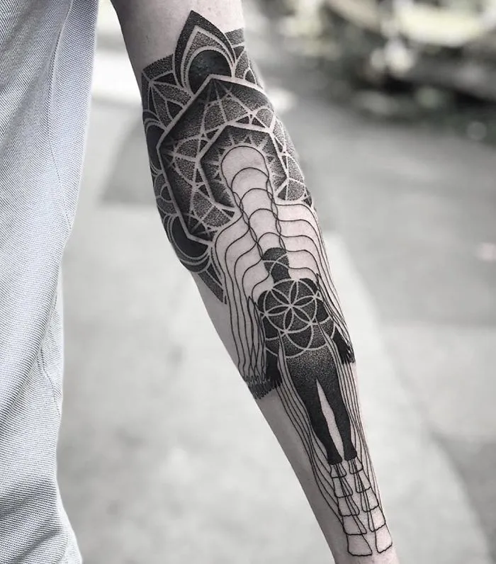 Geometric tattoo design on forearm with intricate patterns for ink lovers.