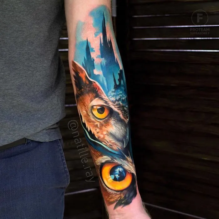 Vibrant owl tattoo design on forearm, featuring contrasting colors and detailed artistry.