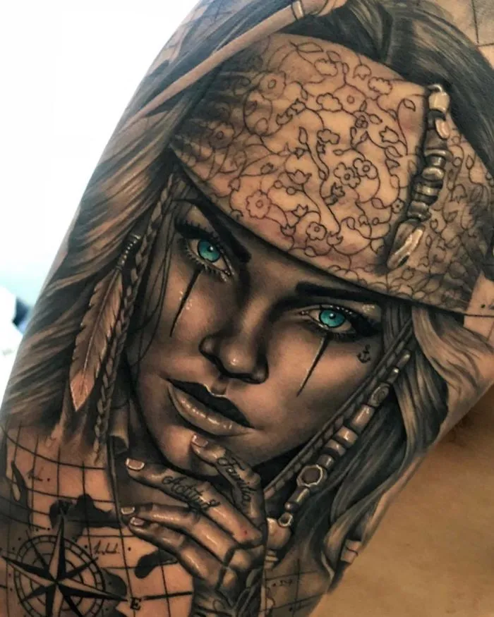 Portrait tattoo of a woman with blue eyes and intricate details on a bicep, showcasing unique tattoo ideas.