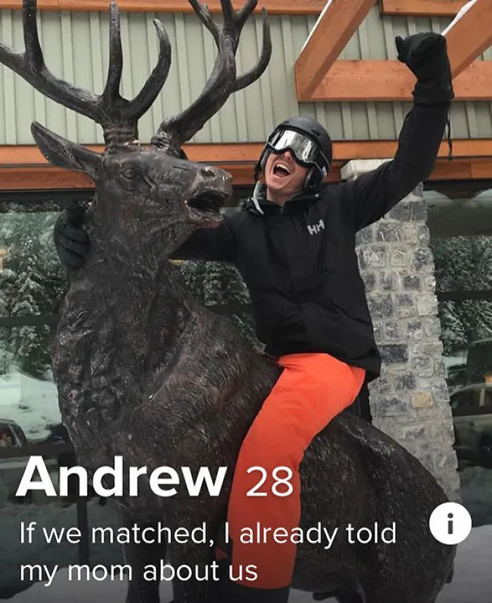 Man in ski gear posing excitedly on a large deer statue featured in funniest tinder profiles collection.