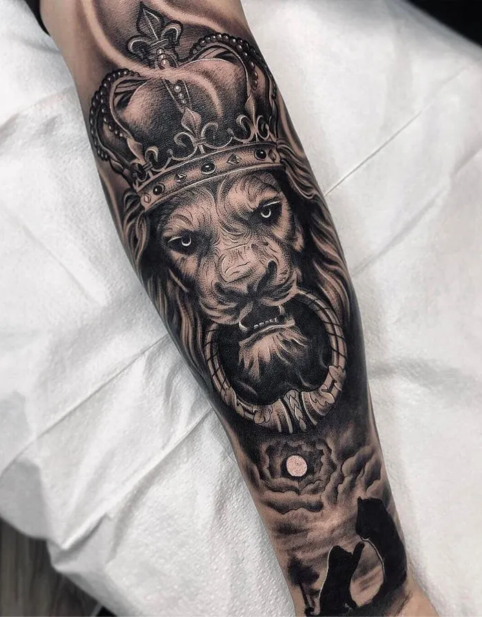 Lion tattoo with crown, intricate design, symbolizing strength and majesty, ideal for ink lovers seeking bold tattoo ideas.