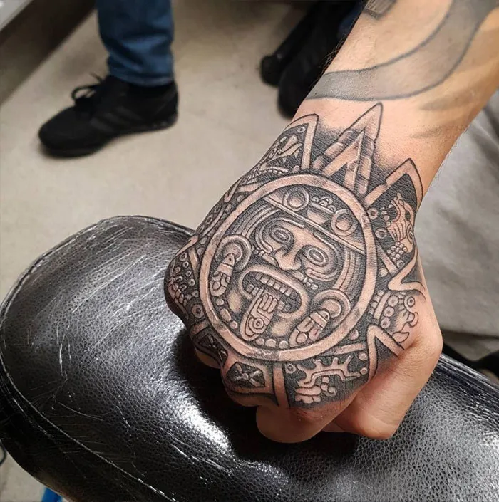 Aztec-inspired tattoo design on a hand, showcasing intricate ink art for tattoo lovers.