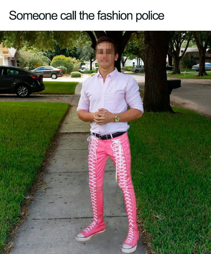 Man in pink lace-up pants and a shirt, standing on a sidewalk, embodying a fashion disaster meme.