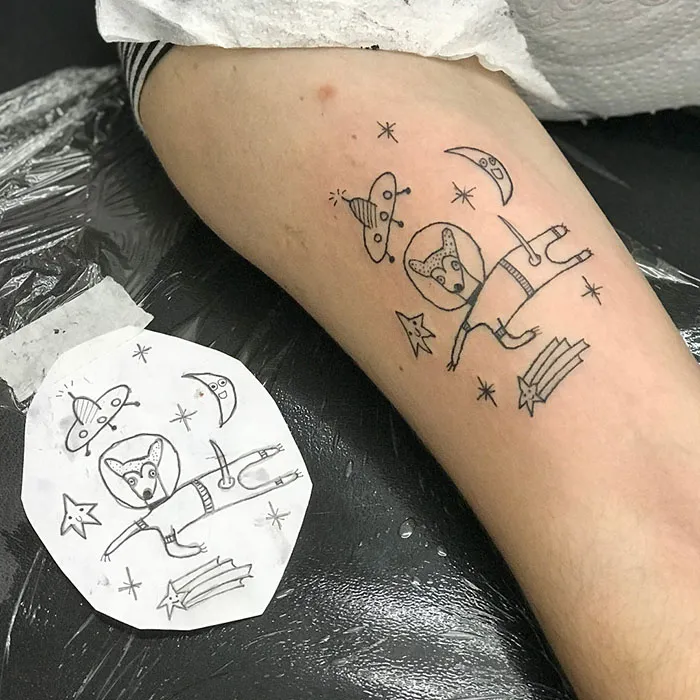 Tattoo of playful, abstract design on leg, showcasing unique artistic style despite lack of traditional drawing skills.