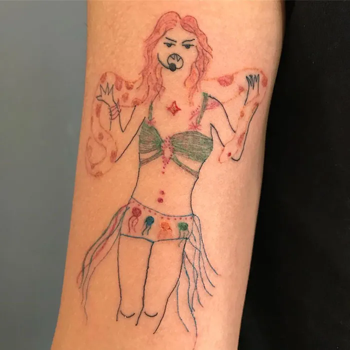 Amateur-style tattoo of a woman on a client's arm, highlighting unique artistry.
