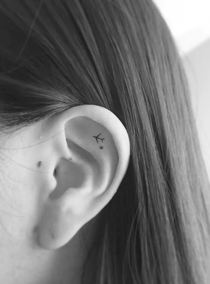 Tiny Wanderlust Ear Tattoo