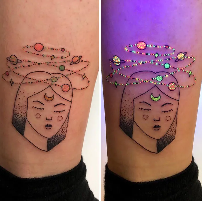 UV tattoo design of a woman's face with cosmic elements, glowing under blacklight.