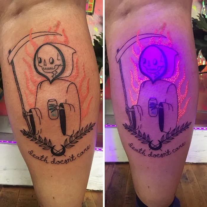 UV tattoo of a grim reaper with scythe, glowing under blacklight, surrounded by flames and leaves, captioned "death doesn't care".