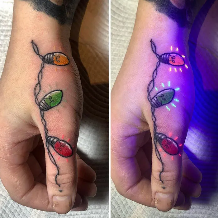 UV tattoo of colorful, glowing lights on a hand, visible under blacklight.