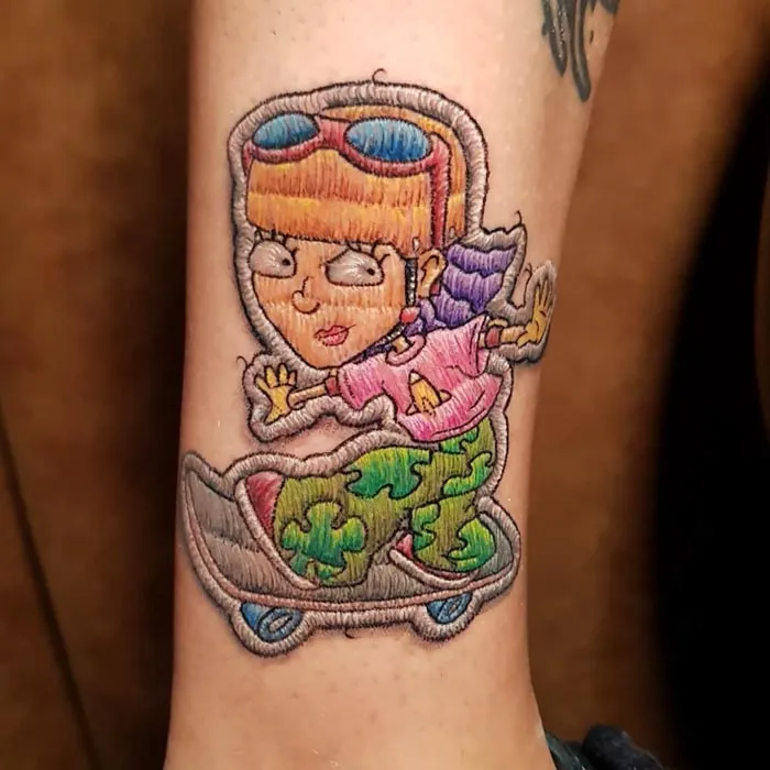 Embroidery tattoo depicting a cartoon skateboarder character, showcasing the unique style of a Brazilian tattoo artist.