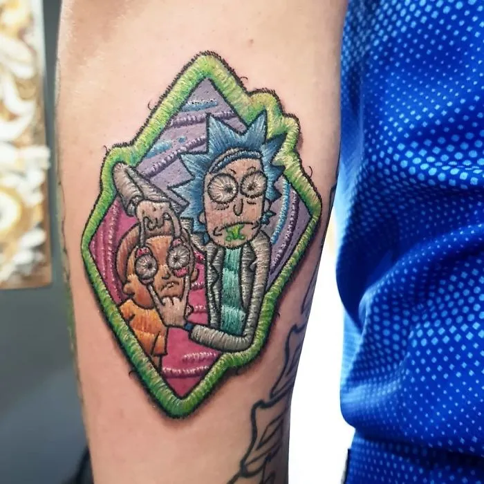 Embroidery tattoo on arm featuring colorful animated characters in a patch-like style.