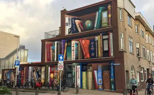 Dutch Artists Paint Giant Bookcase On An Apartment Building Featuring Residents' Favorite Books