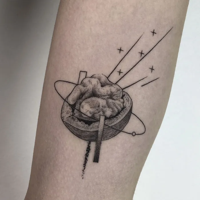Geometric tattoo design on forearm featuring abstract shapes and lines, reflecting personal life events.
