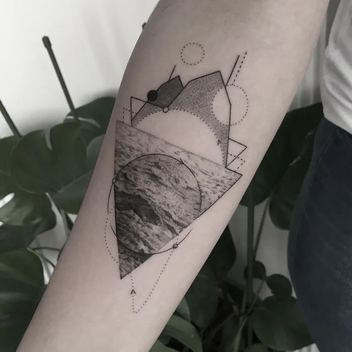 Geometric tattoo design on forearm, featuring shapes and textures, symbolizing life events.