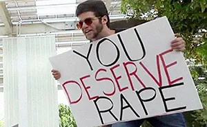 Preacher Carrying 'You Deserve To Be Raped' Sign Gets Hit With A Baseball Bat And The Comments Are Priceless