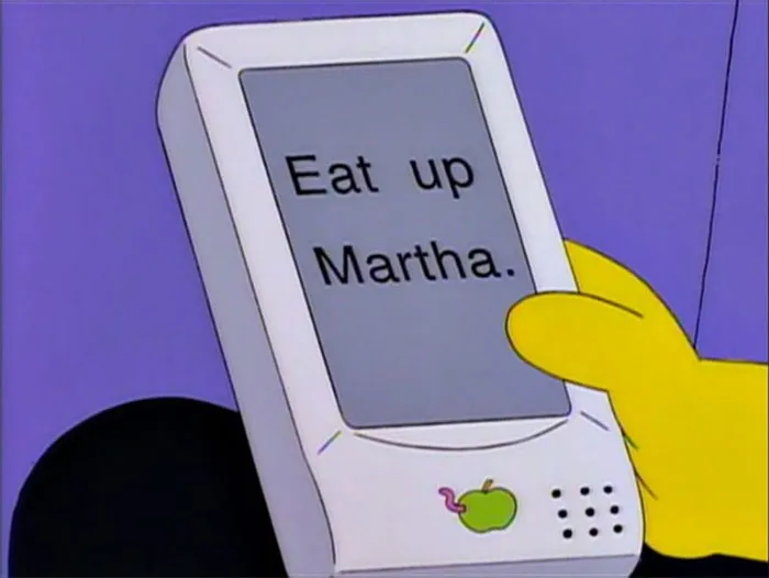 Cartoon hand holding a futuristic device displaying a message, illustrating times cartoons guessed the future.