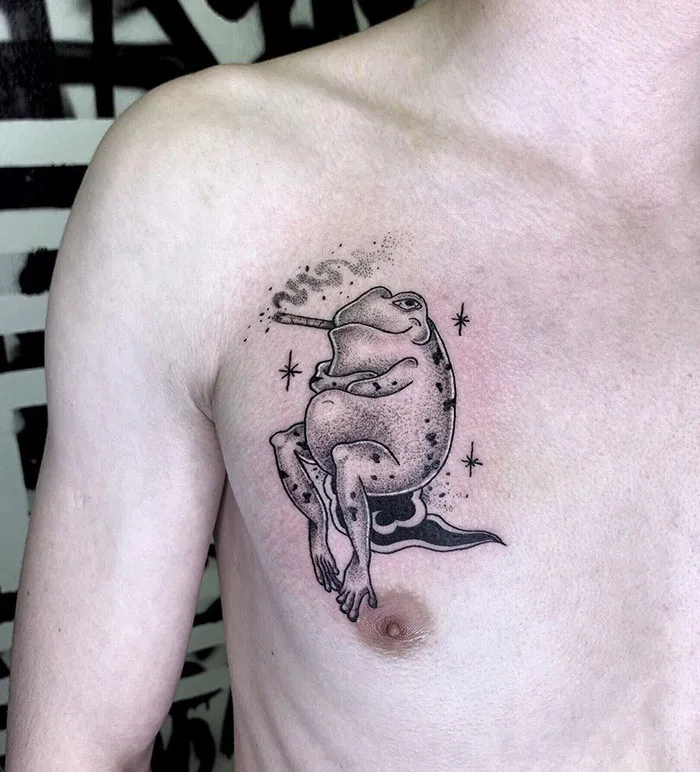 Frog chest tattoo with stars, featuring unique ink design.