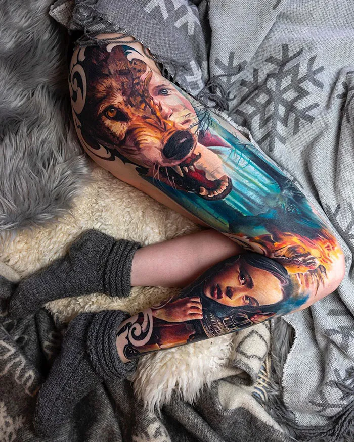 Colorful leg sleeve tattoo featuring a detailed wolf and a woman's face, showcasing intricate artistry and vibrant design.