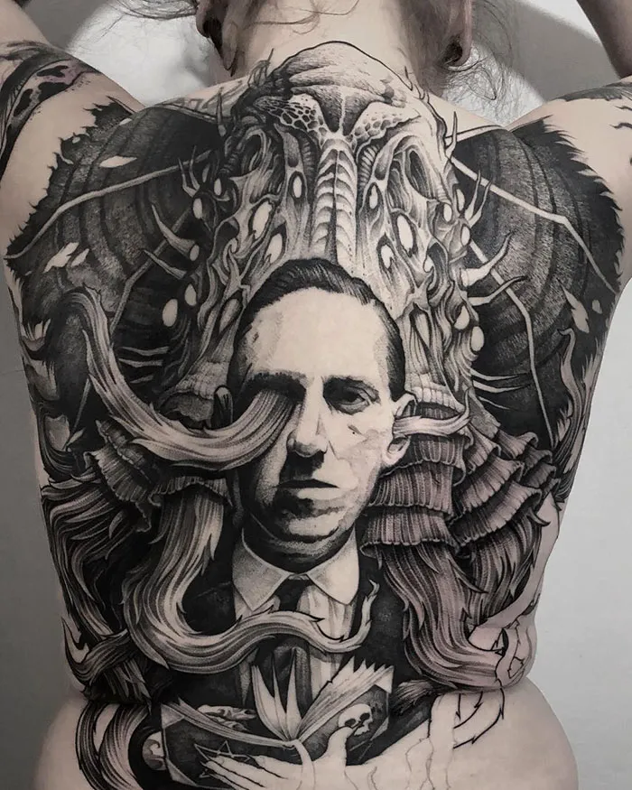 Detailed back tattoo featuring a surreal design with intricate black and grey artwork.