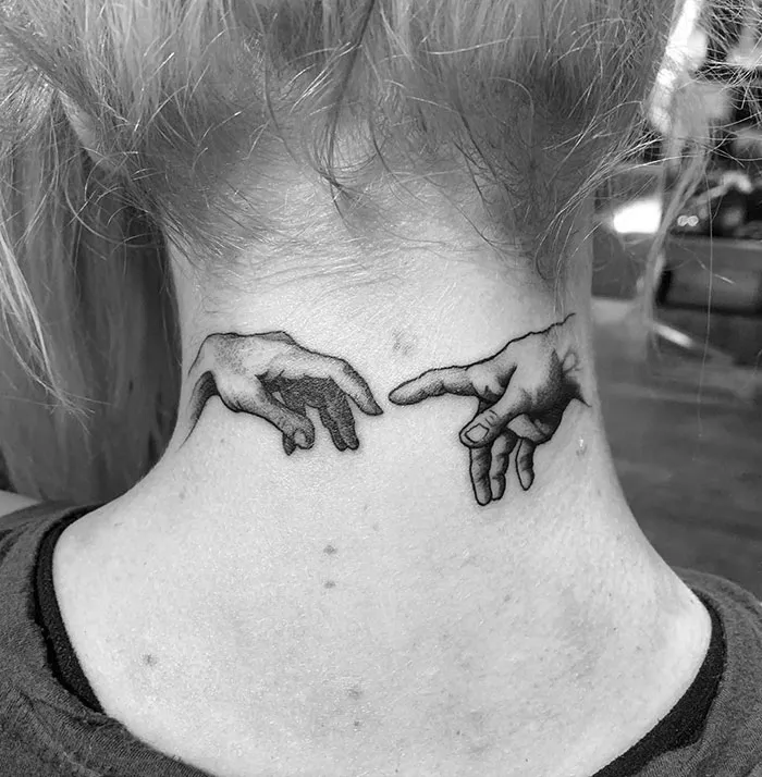 Creative neck tattoo featuring two hands reaching towards each other.