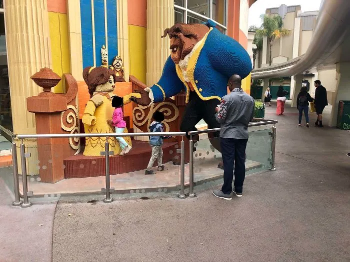 Lifting Your Kids Over A Guard Rail So You Can Ignore Them With Your Smartphone While They Try To Destroy A Display