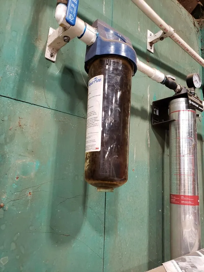This Is The Drinking Water Filter At My Work. It's Been Getting Darker By The Day But My Boss Insists It's Doing Its Job Still