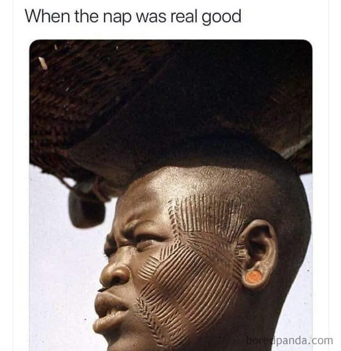 Man with intricate face scarification squinting, capturing a funny sleeping meme about a very good nap experience.