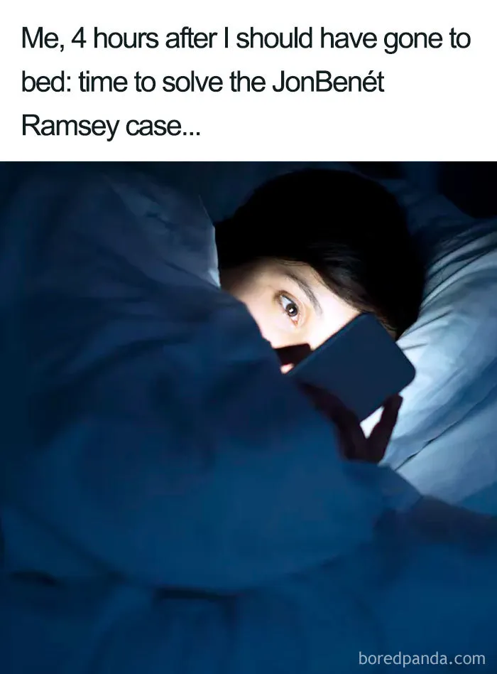 Person lying awake in bed, illuminated by phone light, representing funny sleeping memes about late-night distractions.