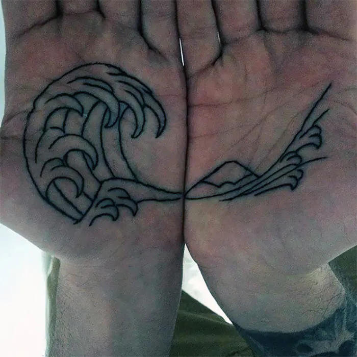 Palm tattoos featuring a wave design across both hands.