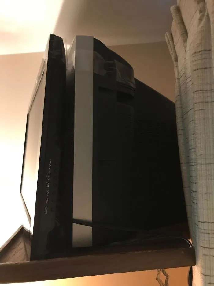 Flat Screen TV Mounted To An Old Box TV With Packing Tape In A Flea Bag Motel