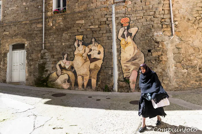 Woman Walking For The Murales In Orgosolo On The Italian Island Of Sardinia