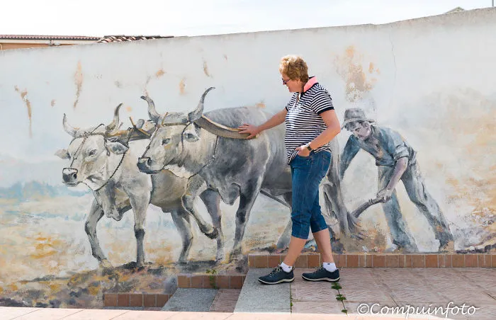 Woman With Murales In Orgosolo On The Italian Island Of Sardinia