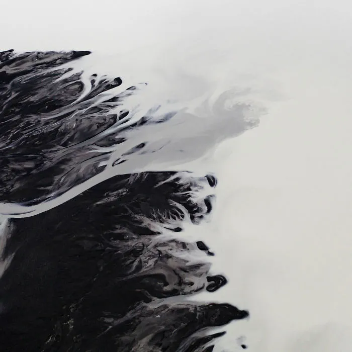 Drone Photo Of Glacial Rivers Cutting Through Black Volcanic Soil