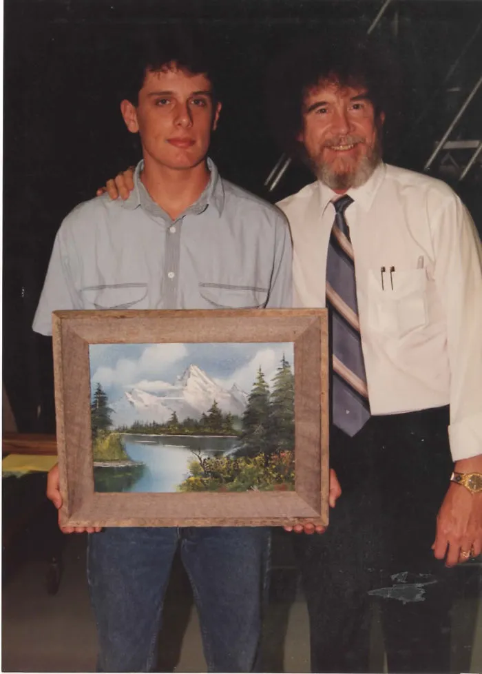 1990: A Fan Gets A Photo With Bob Ross And A Landscape He Painted Using Ross' Series