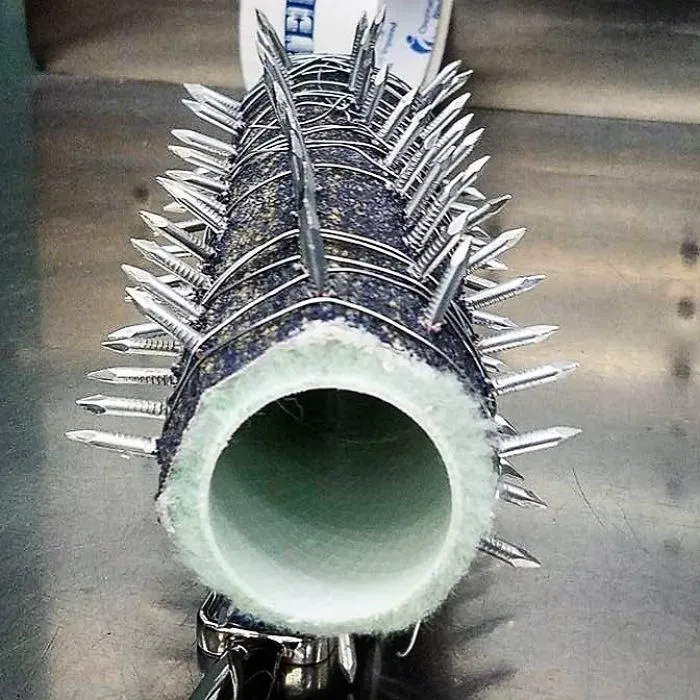 This Looks Like Something Out Of A Mad Max Movie. It’s As If Mad Max Wanted To Paint The Thunderdome With The Blood Of His Enemies. It’s A Paint Roller Wrapped In Sandpaper And Wire With Nails Protruding
