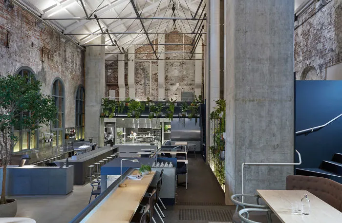 Former Power Station Converted Into An Industrial Cafe And Restaurant With Exposed Brickwork And Abundant Planting In Melbourne, Australia