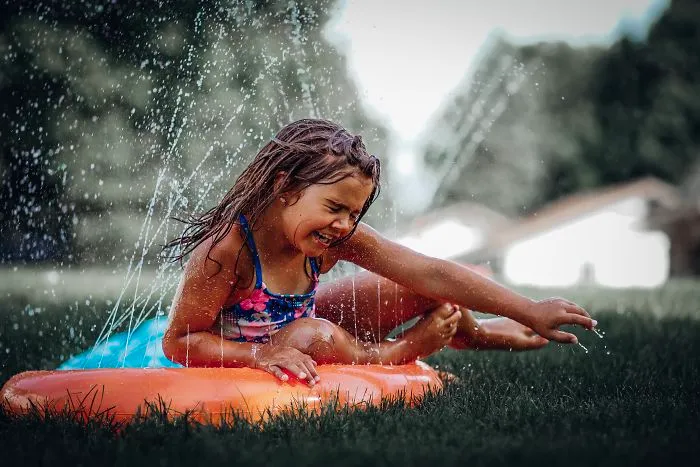 Having Fun On A Summers Day On The Slip And Slide