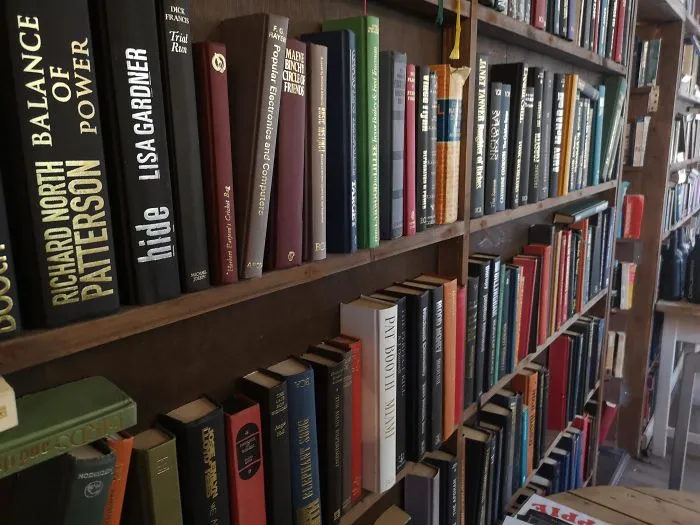 Instead Of Putting In A Bookshelf, This Coffee Shop Cut The Spines Of The Books And Glued Them To A Shelf