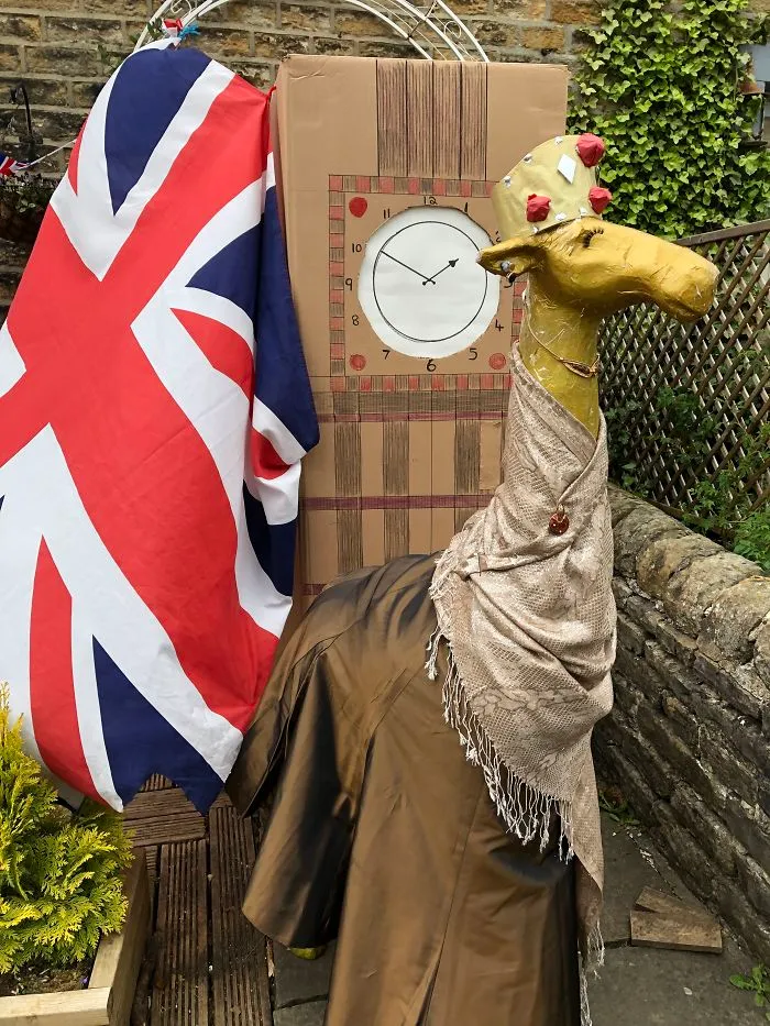 Gloria The Giraffe As Her Majesty The Queen Standing In Front Of Big Ben