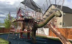 This Dad Should Win An Award For Building An Incredible 14-Meter Dinosaur Jungle Gym For His Kids