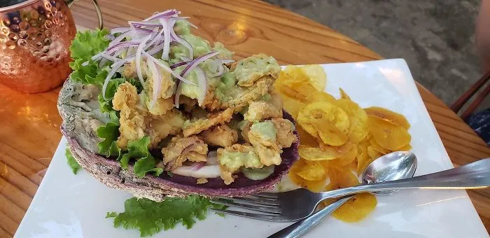 The One Vegetarian Entrée At This Restaurant Is Served Inside The Shell Of A Dead Sea Creature