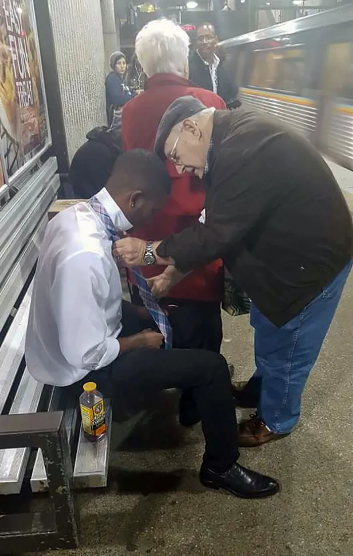 Older Gentleman Teaches Young Guy How To Tie His Tie